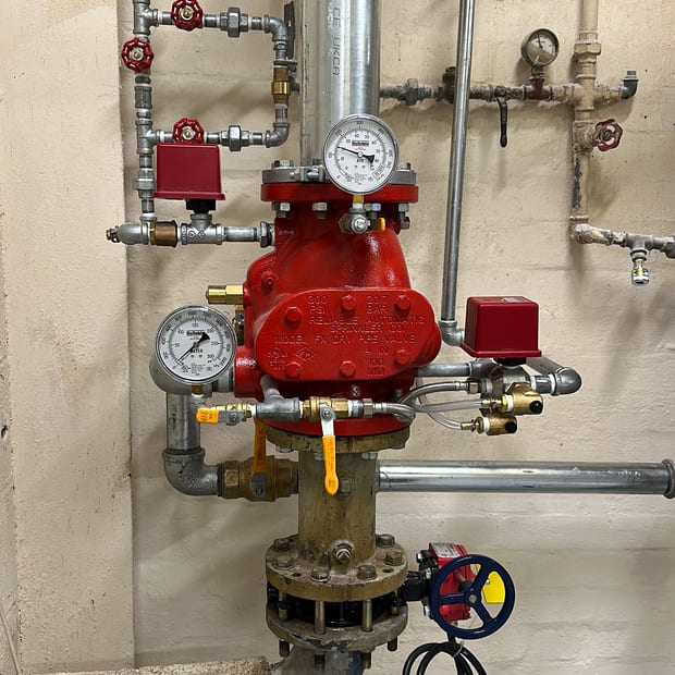 Large alarm valve set with gauges and trim in a plant room