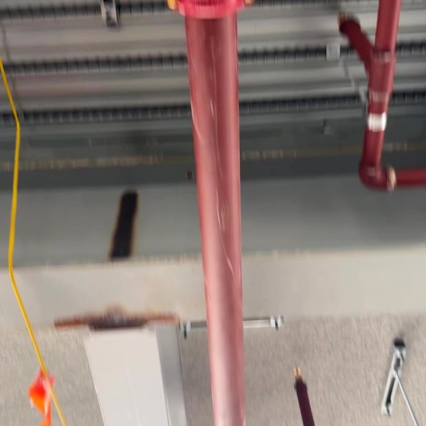 Sprinkler drop and riser at a soffit during fit-out