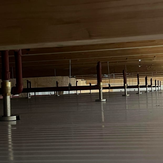 Sprinkler drops running under a deck in a service void