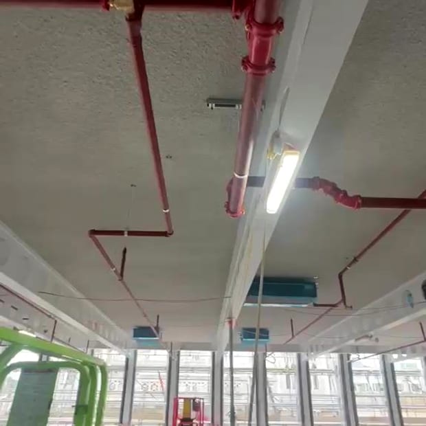 Installing sprinkler pipework from a scissor lift
