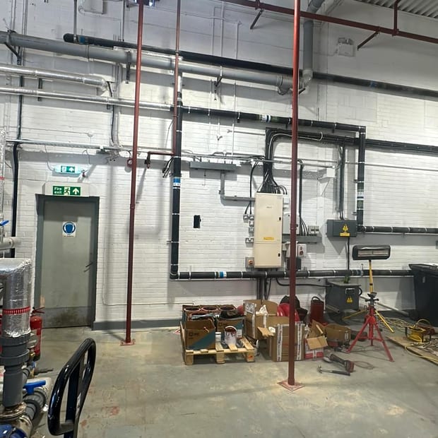 Riser pipework running through a plant room