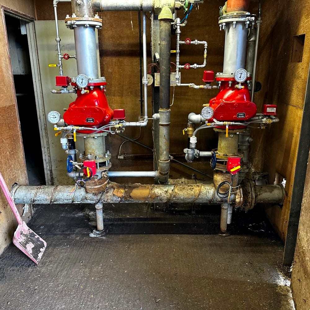 Two alarm valve sets and their gauges in a riser cupboard
