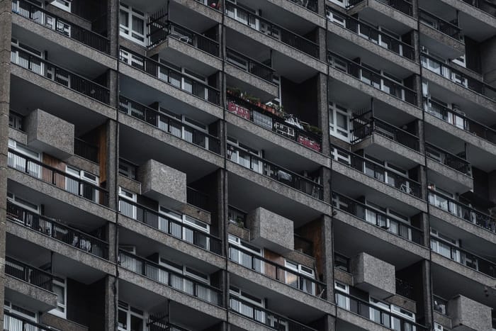 A high-rise residential block with rows of balconies