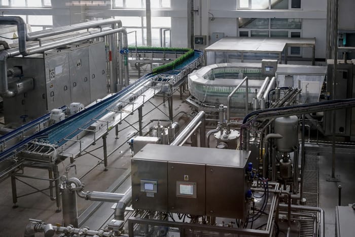 A bottling line and stainless process pipework in a food plant