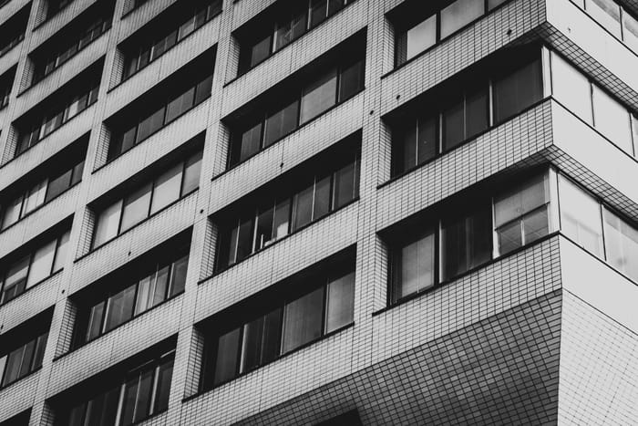 A multi-storey institutional building with banded windows