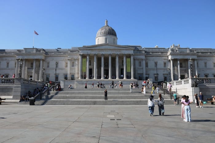 A classical gallery building with a columned portico and dome