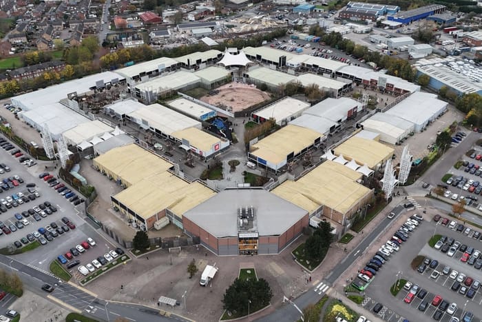 An aerial view of an open-air shopping centre and its car parks